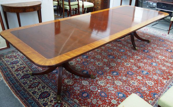 A George III style satinwood banded mahogany 'D' end extending dining table, on eight downswept supports, two include two extra leaves, 117cm wide x 1