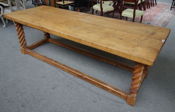 A thick oak four plank kitchen table, on a pitch pine base with barleytwist supports, 89cm wide x 243cm long.