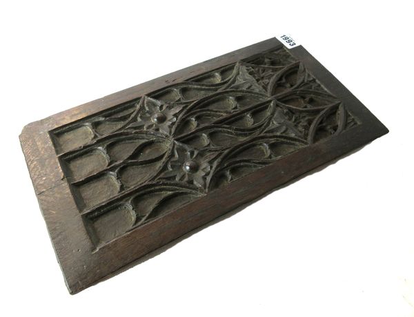 A 16th century French oak blind tracery panel, relief carved with interlocking diamonds, 20cm wide x 38cm high.