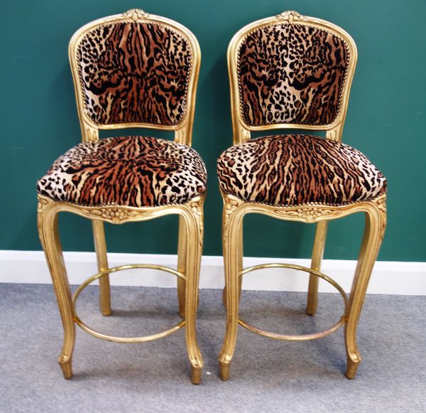 Peter Stringfellow's, Angels Club; a set of four leopard print upholstered barstools with gold painted frames, each 46cm wide x 110cm high. Sold with