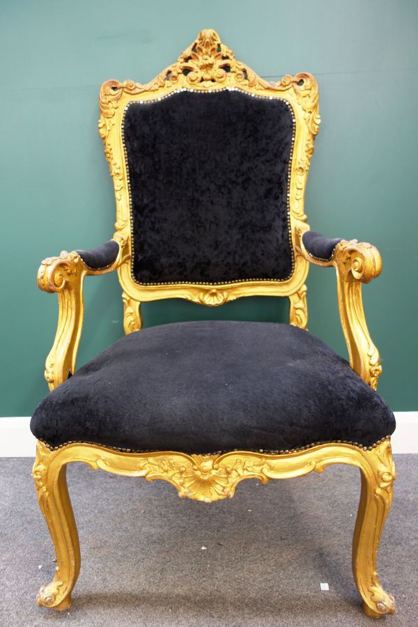 Peter Stringfellow's, Angels Club; a gilt framed open arm throne chair with black upholstery on scroll supports, 75cm wide x 136cm high. Sold with aut