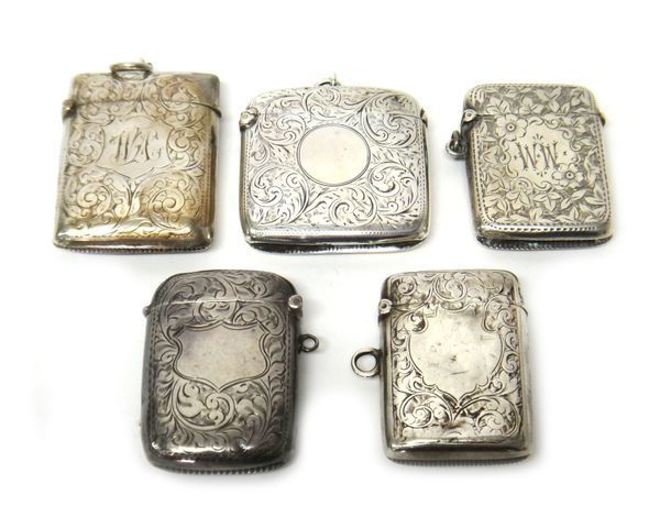 A late Victorian silver rectangular vesta case, with engraved decoration, Chester 1900 and four further silver rectangular vesta cases, combined gross