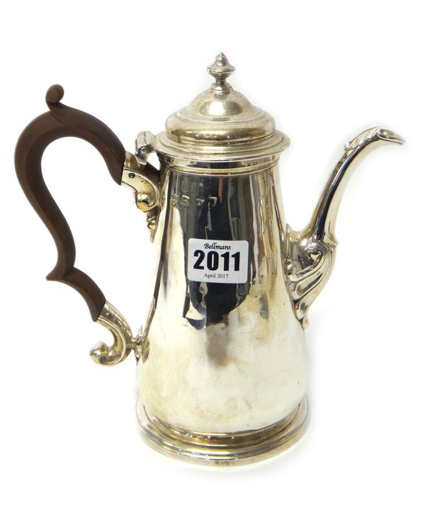 A silver teapot, 18th century, of tapering cylindrical form, with a replacement wooden handle, on a circular foot, (the marks rubbed), gross weight 69