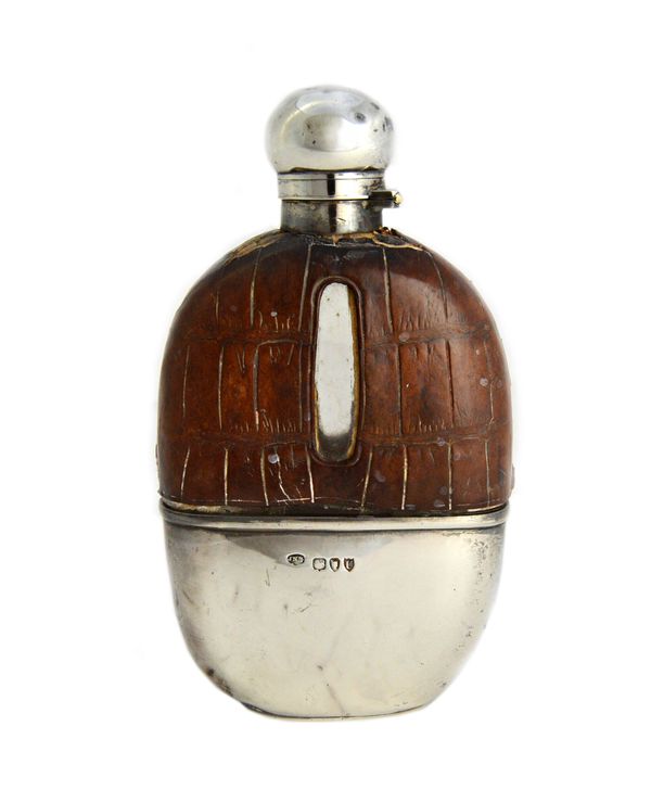 A Victorian silver mounted and partly leather covered glass spirit flask, of ovoid form, the pull-off beaker base London 1895.   Illustrated