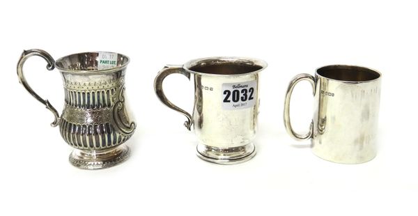 A silver christening mug, with a scrolling handle, Birmingham 1920, a silver smaller christening mug, with a 'C' shaped handle, Sheffield 1900, combin