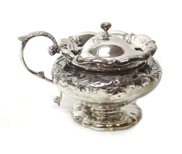 A William IV silver mustard pot, of compressed circular form, decorated with a floral and foliate band, on a shaped circular foot (the glass liner lac