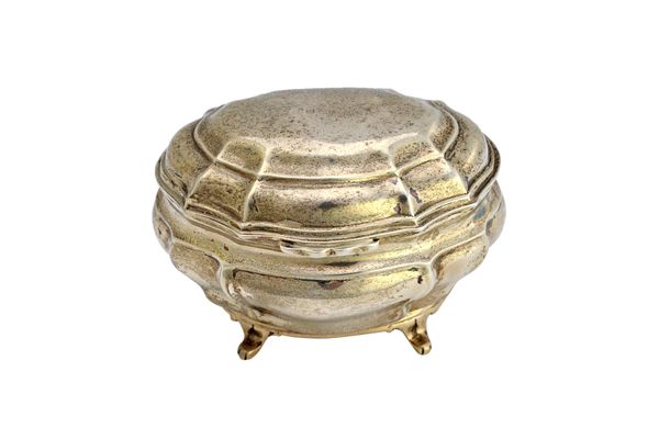 A silver late Victorian hinge lidded tea caddy, of shaped oval bombe rococo form, raised on four feet, London 1900, weight 242 gms.   Illustrated