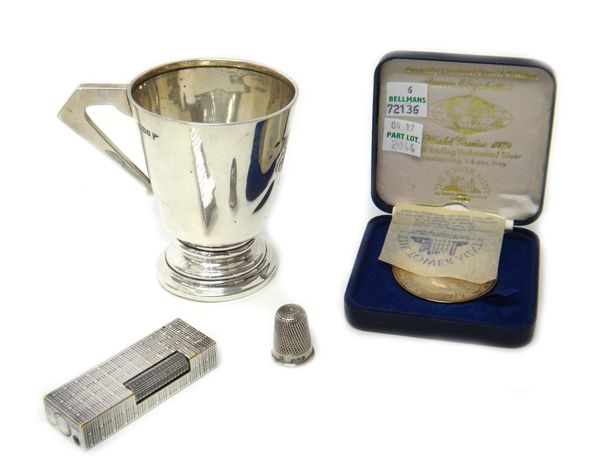 A silver christening mug, with an angular handle, Sheffield 1910, a silver thimble, Chester 1891, a silver medallion, commemorating Queen Elizabeth 2