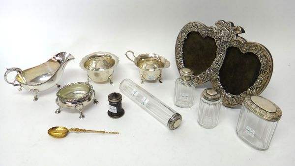 Silver and silver mounted wares, comprising; a twin compartment heart shaped photograph frame, with embossed decoration, a milk jug with a matching su