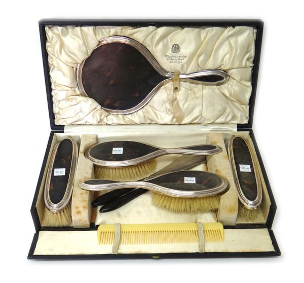 A lady's silver mounted tortoiseshell five piece dressing set, comprising; a hand mirror, a pair of hairbrushes and a pair of clothes brushes, London