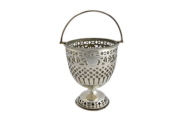 A silver sugar basket, having pierced decoration, raised on a pierced circular foot, decorated with beaded rims and with a beaded swingover handle, fi