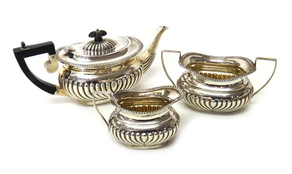 Silver, comprising; a matched three piece tea set, comprising; a teapot, Birmingham 1902, a twin handled sugar bowl, Birmingham 1903 and a similar mil