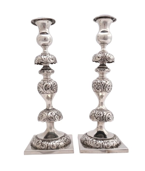 A pair of Polish table candlesticks, each with a knopped floral and foliate decorated stem and on a square base, detailed W. LUTHER, WARSZAWIE I.S. 18