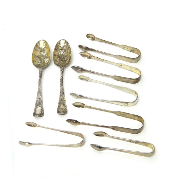 Silver, comprising; two bottom marked dessert of fruit serving berry spoons and six pairs of sugar tongs, in a variety of designs, combined weight 375