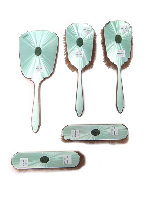 A lady's silver and pale green enamel mounted and jade set five piece Art Deco dressing set, comprising; a hand mirror, a pair of hairbrushes and a pa