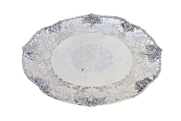 A silver centrepiece dish, decorated with an engraved cast and pierced border, designed as fruiting vine, the centre engraved with a coat of arms and