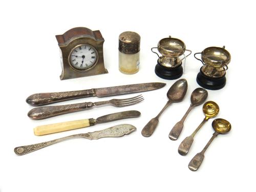 Silver and silver mounted wares, comprising; a small oak clock, a smelling salts bottle, two three handled trophies, Sheffield 1905, with black stands