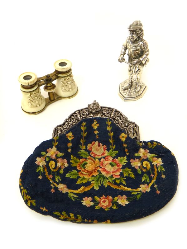 A silver mounted lady's needlework bag, the mount embossed and pierced with putto and floral scrolls, fitted with a carrying chain, import mark Cheste