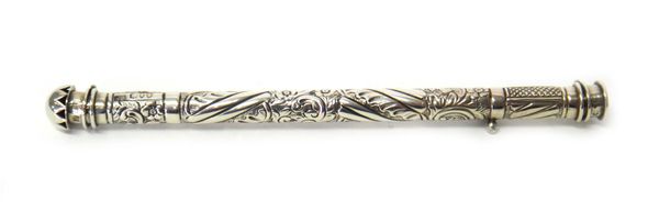 A late Victorian silver vesta case cum taper holder, of cylindrical form, with floral spiral fluted and scroll embossed decoration, hinged at either e