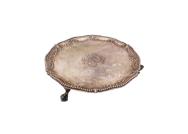 A George III silver waiter, of shaped circular form, decorated with a border of linenfold swags within a shaped beaded rim, the centre monogram engrav