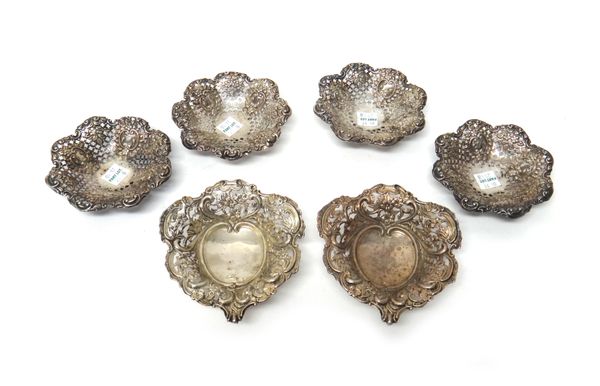 A set of four late Victorian silver bonbon dishes, each of shaped circular form with embossed and pierced decoration, Sheffield 1900 and a pair of Vic