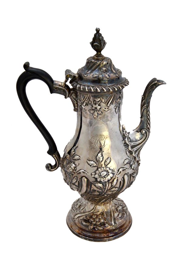 A George III silver coffee pot, of baluster form, with floral and fluted decoration and with a bud finial to the hinged cover, raised on a circular fo