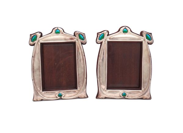 A matched pair of Art Nouveau silver and enamelled shaped rectangular photograph frames, the centre of the top and of the bottom with enamelled heart