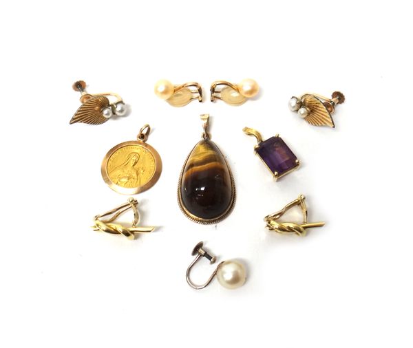 A gold pendant, mounted with a drop shaped tiger's eye, detailed 9 CT, a gold and amethyst set single stone pendant, a devotional pendant, a pair of g