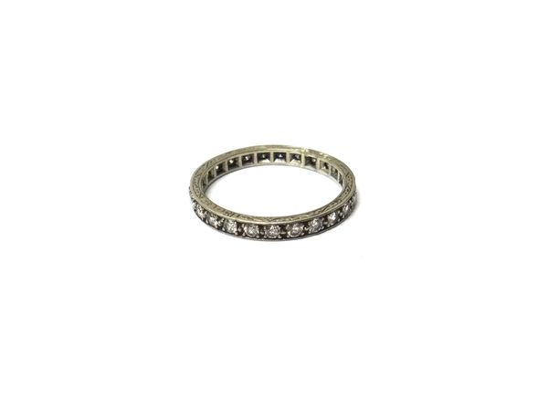 A white gold and diamond set full eternity ring, mounted with circular cut diamonds, the mount decorated with engraved sides and detailed 18 CT C & F,