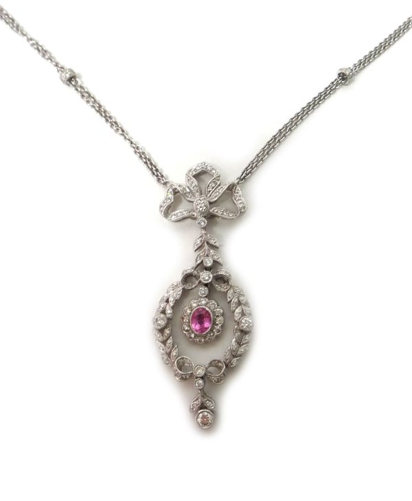 A white gold, diamond and pink sapphire set pendant necklace, the centre mounted with an oval cut pink sapphire, in a surround of circular cut diamond