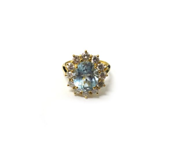 An 18ct gold, aquamarine and diamond oval cluster ring, claw set with the oval cut aquamarine at the centre, in a surround of circular cut diamonds, r