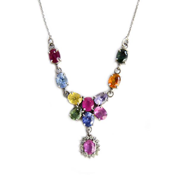 A white gold, diamond, sapphire and vary coloured gemstone set pendant necklace, the front with an oval cluster drop and otherwise further set with te