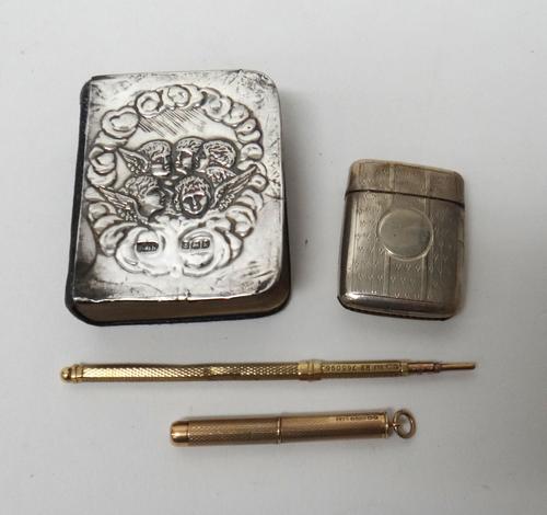 A gold cased slide action pencil, detailed 9 CT, a 9ct gold cased propelling toothpick, Birmingham 1955, a silver vesta case, Birmingham 1919 and a si