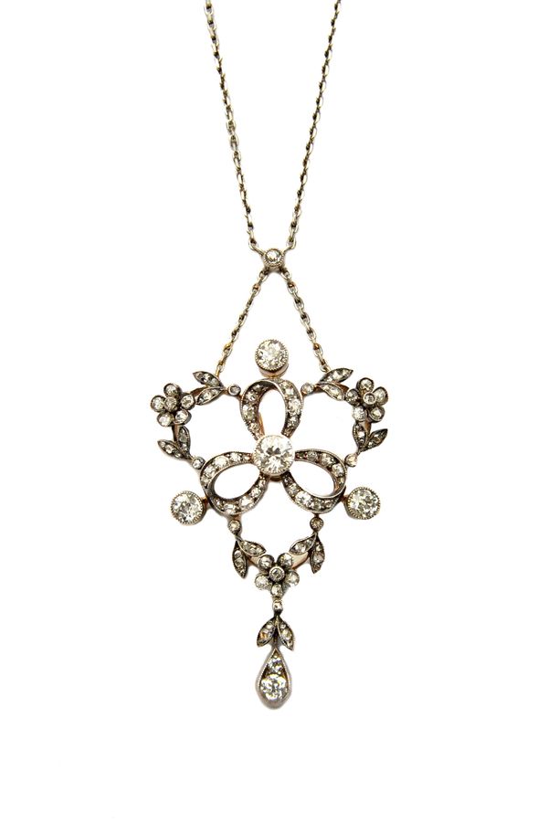 A diamond set pendant necklace, in a pierced trefoil, floral and foliate openwork design, mounted with cushion shaped and rose cut diamonds and with t