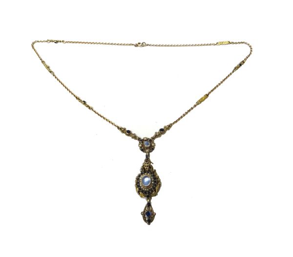 A moonstone, seed pearl and blue gem set pendant necklace, probably Austro Hungarian, the drop mounted with the principal oval moonstone within a seed