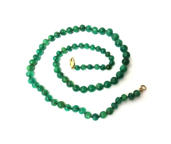 A single row necklace of graduated emerald beads, on a gold sprung hook shaped clasp, length excluding clasp 48cm, gross weight 28.3 gms, with a case.