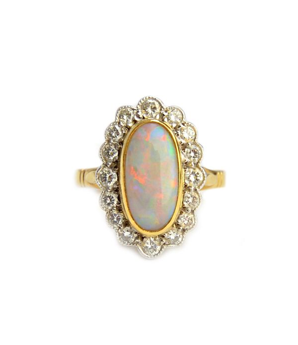 A gold, opal and diamond set oval cluster ring, collet set with the oval opal at the centre, in a surround of circular cut diamonds, ring size J, with