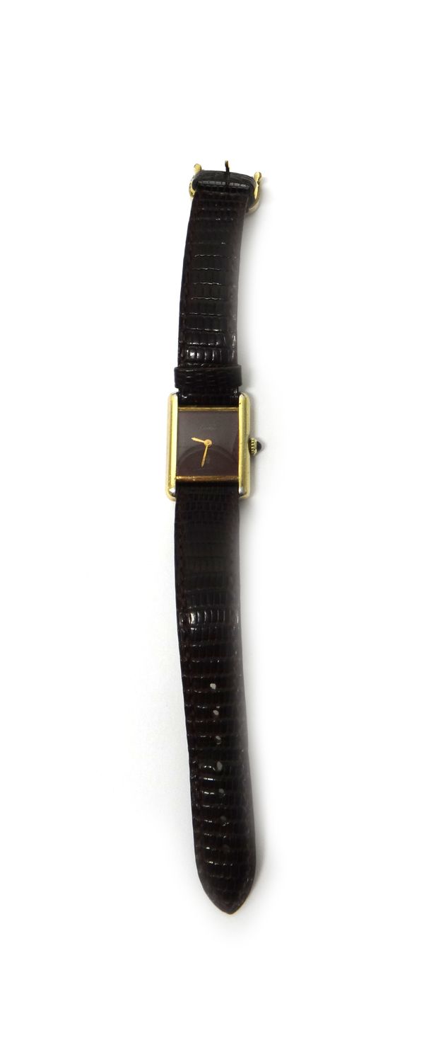 A lady's silver gilt rectangular cased must de Cartier wristwatch, with a signed burgundy coloured dial, gilt hands, the signed case back detailed Car