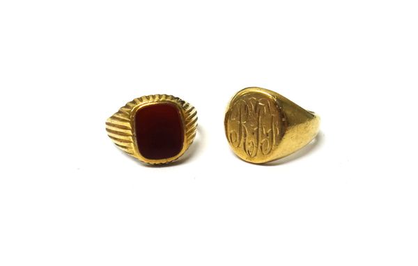 A 9ct gold oval signet ring, monogram engraved, ring size Q and a 9ct gold and cornelian set signet ring, with ridged decoration, ring size R, gross c