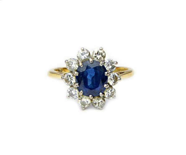 An 18ct gold, sapphire and diamond oval cluster ring, claw set with the oval cut sapphire at the centre, in a surround of ten circular cut diamonds, r