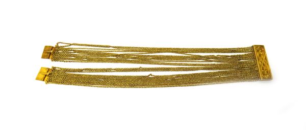 A mid 19th century gold bracelet, in a wide multiple strand design, on a twin section rectangular snap clasp, with engraved decoration, length 17cm, w