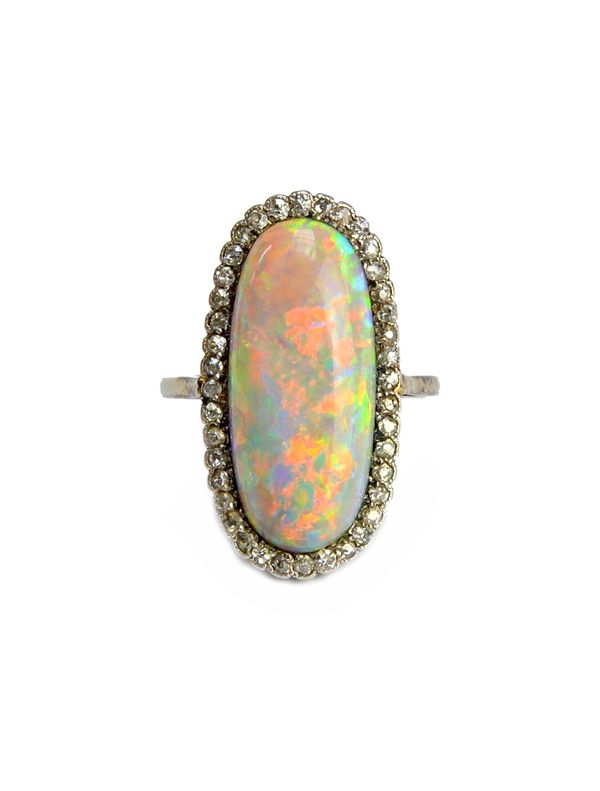 A white gold and platinum, opal and diamond ring, mounted with the oval opal to the centre, within a surround of cushion shaped diamonds, detailed 18