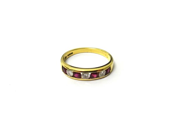 An 18ct gold, diamond and treated ruby seven stone ring, mounted with a row of four circular cut rubies alternating with three circular cut diamonds,