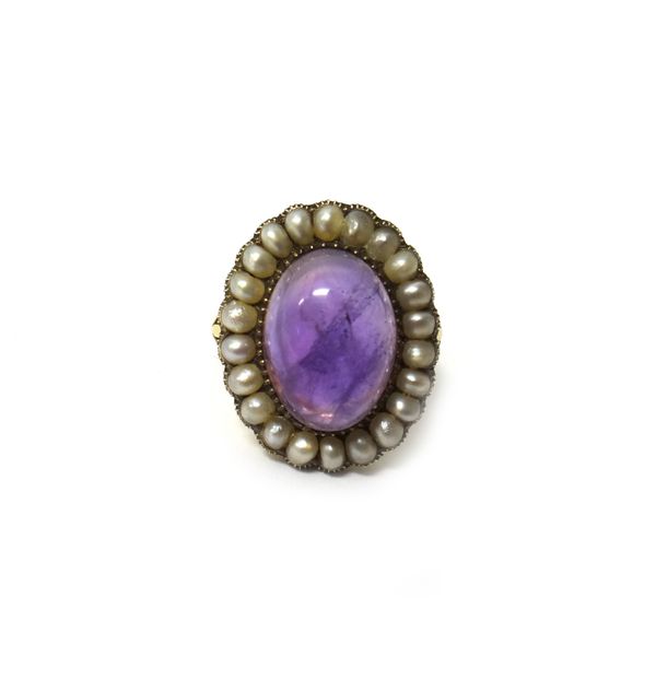 A gold, seed pearl and cabochon amethyst set oval cluster ring, mounted with the oval cabochon amethyst at the centre, within a surround of half pearl