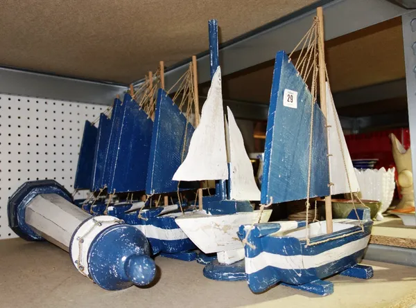 A quantity of 20th century blue painted wooden boats and a similar wooden lighthouse.  SH7