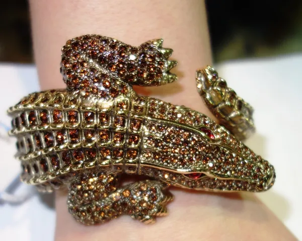 A gilt metal and paste hinged bangle by Roberto Cavalli, formed as an alligator.    CAB