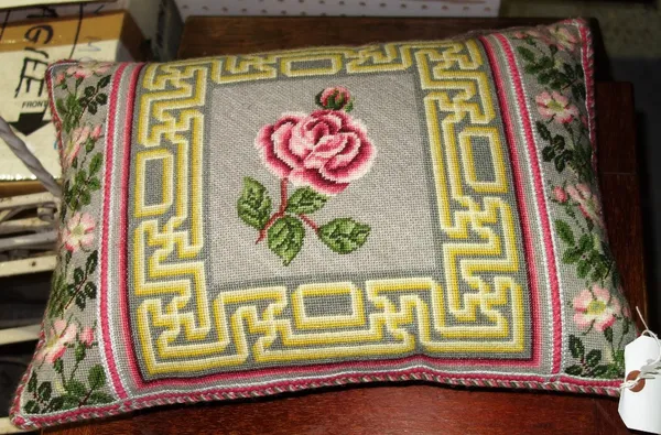 A needlework cushion with rose decoration.  J6