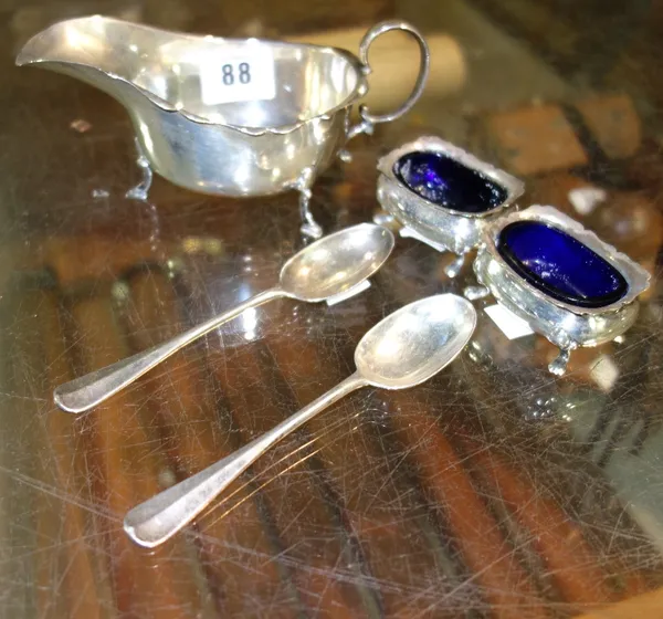 A silver sauce boat, with wavy rim and raised on three pad feet, a pair of silver salts with blue glass liners and a pair of Victorian silver teaspoon
