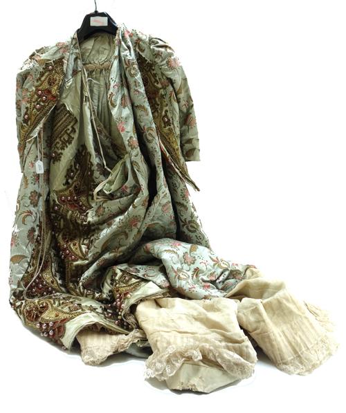 A lady's silk embroidered waistcoat and skirt, 19th century, detailed with exotic flowers against a green ground, with gilt and beadwork embellishment