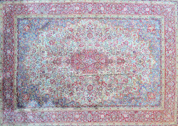 A Kerman carpet, Persian, the pale sage field with a bold madder medallion, pale indigo spandrels, all with delicate and intricate floral sprays, a co
